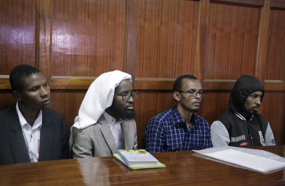 From left to right, defendants Rashid Charles Mberesero, Sahal Diriye Hussein, Hassan Aden Hassan and Mohamed Abdi Abikar, sit in the dock to hear their verdict at a court in Nairobi, Kenya Wednesday, June 19, 2019. The Kenyan court found Mberesero, Hassan and Abikar guilty of conspiracy to commit a terror attack after phone records and handwriting linked them to the 2015 Garissa University assault that killed 148 people, while a fourth person, Sahal Diriye Hussein, was acquitted. (AP Photo/Khalil Senosi)