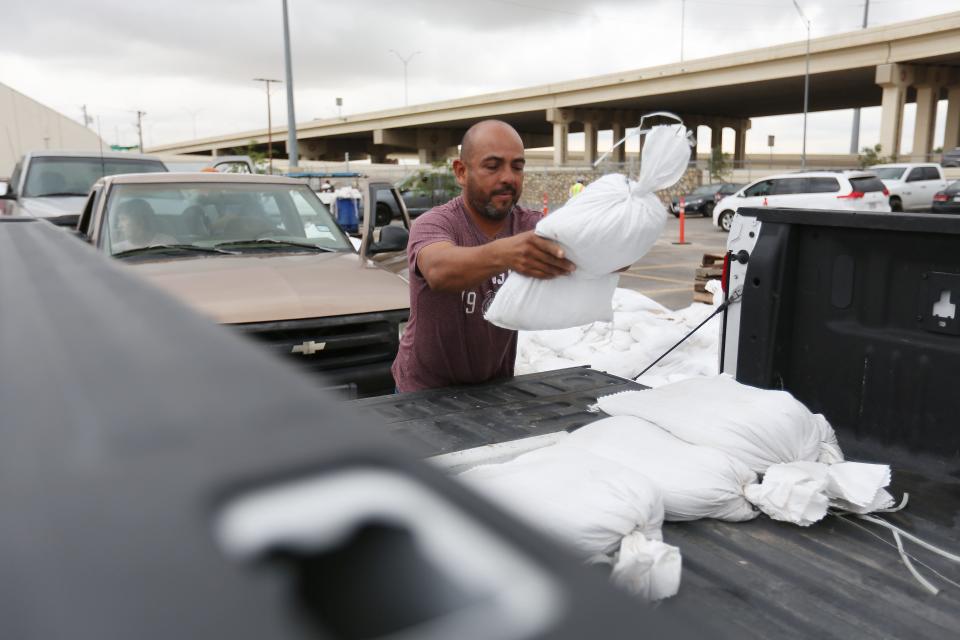 Eduardo Ceja prepares for more rain and thunderstorms by picking up sandbags at the El Paso Water Stormwater Operations Center Friday, Aug. 13, 2021, in El Paso.