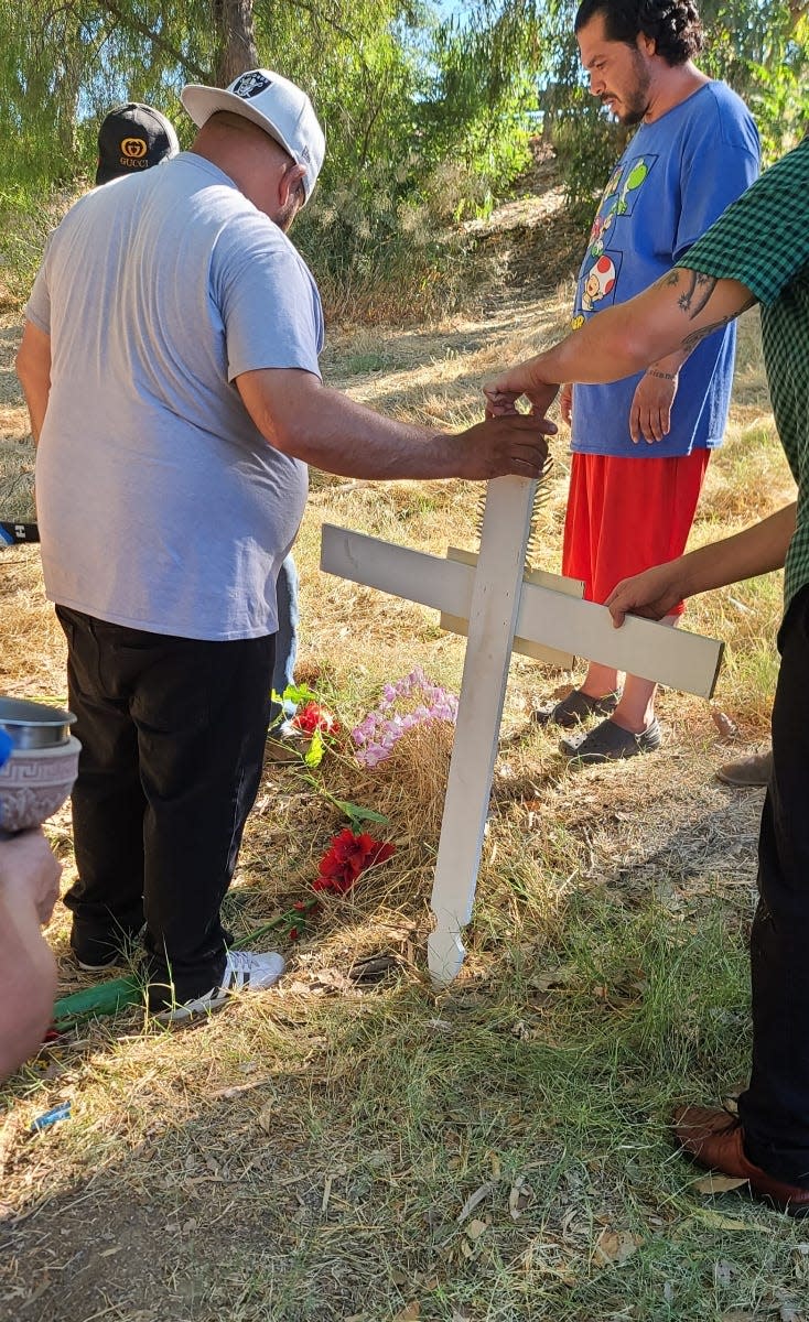 Family members put up a makeshift memorial for Christine Chavez at the site where she was killed in Modesto, California.