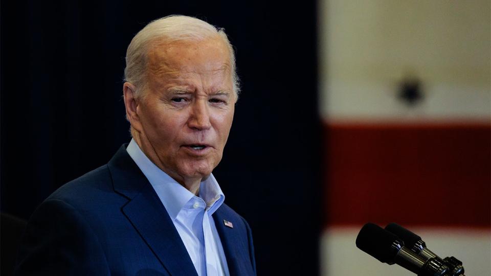 President Biden in blue shirt and navy blue coat