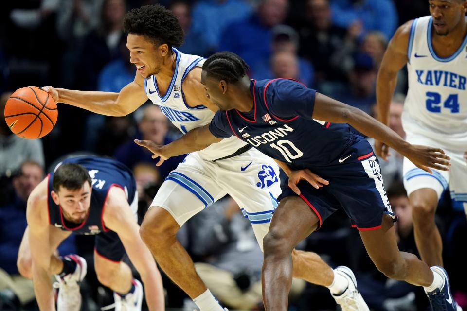 Xavier Musketeers guard Desmond Claude (1) steals the ball from Connecticut Huskies guard Hassan Diarra (10) in the first half of a college basketball game between the Connecticut Huskies and the Xavier Musketeers, Wednesday, Jan. 10, 2024, at Cintas Cetner in Cincinnati.