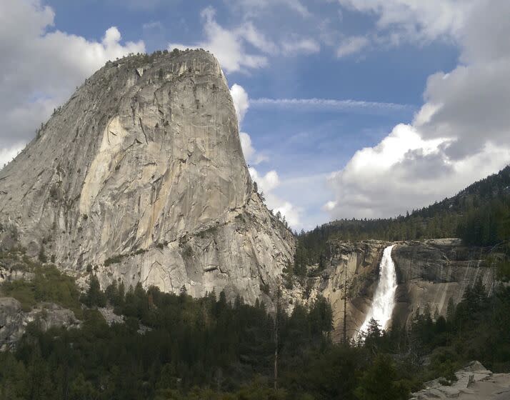 FILE - In this March 28, 2016, file photo provided by the National Park Service, water flows over the Nevada Fall near Liberty Cap as seen from the John Muir Trail in Yosemite National Park, Calif. The National Park Service says a man died after falling into a river at Yosemite National Park on Christmas Day. A government spokesman says rangers responding to a 911 call arrived on scene in less than an hour and provided medical aid, but the man died from a head injury. The park says an investigation into the death is taking longer than usual because of the partial government shutdown. (National Park Service via AP, File)