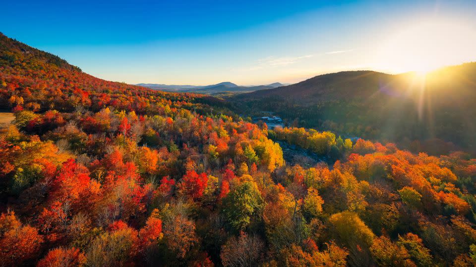 Sunrise illuminates fall colors in the Adirondacks in New York state. More than 40 peaks in the chain reach over 4,000 feet (1,219 meters). - heyengel/iStockphoto/Getty Images