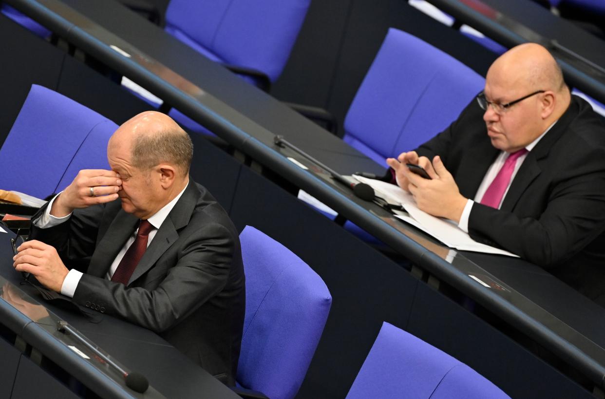 German Finance Minister and Vice-Chancellor Olaf Scholz (L) gestures as German Economy Minister Peter Altmaier checks his mobile phone during a debate at the Bundestag (lower house of parliament) in Berlin on December 8, 2020. (Photo by John MACDOUGALL / AFP) (Photo by JOHN MACDOUGALL/AFP via Getty Images)