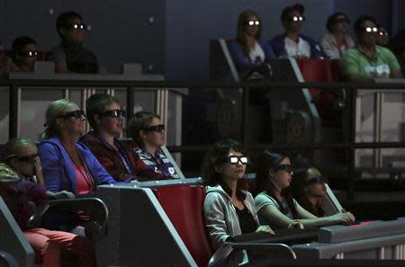 People wear 3D glasses while riding the new "Despicable Me Minion Mayhem" ride during technical rehearsals for the new attraction at Universal Studios Hollywood in Universal City, California March 28, 2014. REUTERS/Jonathan Alcorn