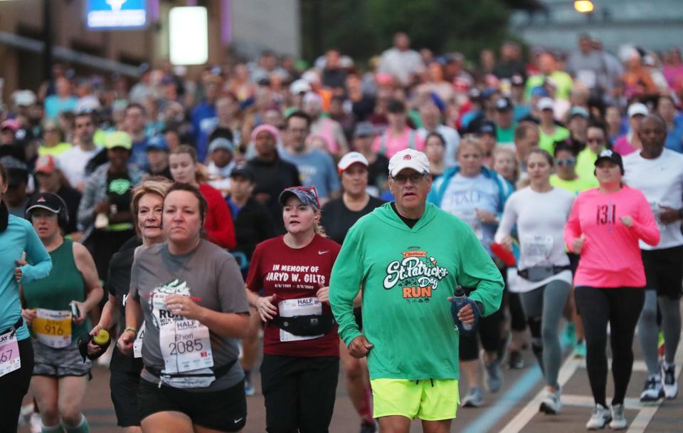 Runners head downhill after the start during the 20th Akron Marathon in Akron on Saturday.