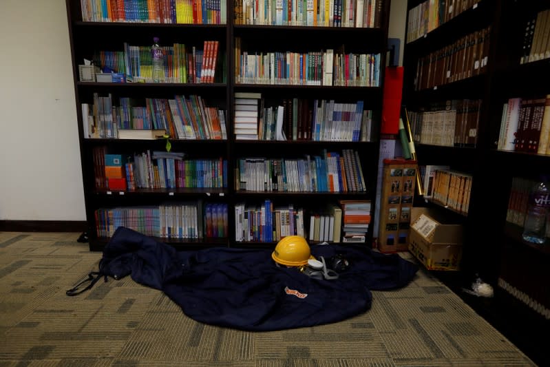 A helmet, gas mask, and sleeping of a protester is left behind in the library of in Hong Kong Polytechnic University (PolyU) in Hong Kong