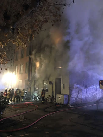 Firefighters are seen in front of a house where six people were killed in an apartment fire early on Monday morning, police said, while an unspecified number of others caught in the blaze were taken to the hospital in Solothurn, Switzerland November 26, 2018. Polizei Kanton Solothurn/Handout via REUTERS.