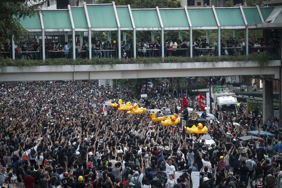 Large inflatable ducks, often associated with protests, are passed around the crowd at a pro-democracy rally in Bangkok, Thailand, Wednesday, Nov. 18, 2020. Police in Thailand's capital braced for possible trouble Wednesday, a day after a protest outside Parliament by pro-democracy demonstrators was marred by violence that left dozens of people injured. (AP Photo/Sakchai Lalit)