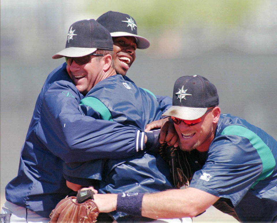 FILE - In this March 24, 1997, file photo, Seattle Mariners' Ken Griffey Jr., rear, and Jay Buhner, right, tease a ticklish Edgar Martinez following a team batting practice at spring training in Peoria, Ariz. Martinez was elected to baseball's Hall of Fame Tuesday, Jan. 22, 2019. (AP Photo/Elaine Thompson, File)