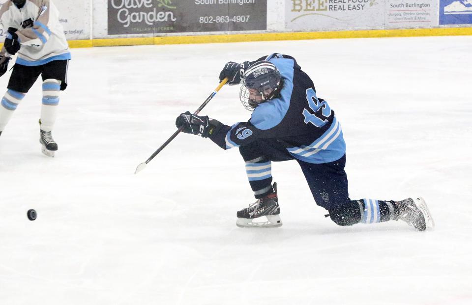 MMU sophomore Garret Carter fires a shot on goal from his knees during the Cougars 5-1 loss to South Burlington in the 2024 D1 semifinals at Cairns Arena.