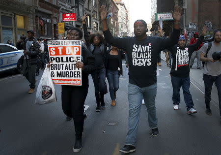 Protesters march with their hands up during a demonstration in the Manhattan borough of New York City calling for social, economic, and racial justice April 29, 2015. REUTERS/Mike Segar