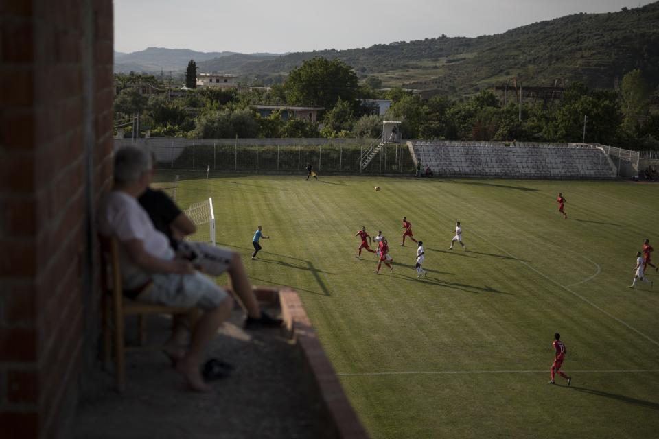 Vecinos de la ciudad siguen desde sus tejados el partido entre el Bilys Ballsh y el Partizán de Tirana, que se juega a puerta cerrada por el coronavirus. (Foto: Daniel Cole / AP).