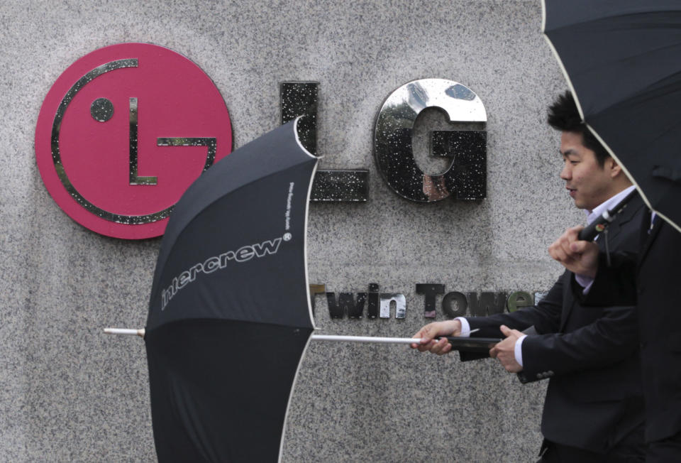 A South Korean man walks by a logo of LG Electronics Inc. in front of the company's headquarters in Seoul, South Korea, Wednesday, April 25, 2012. LG Electronics Inc. posted its first profit in three quarters, beating expectations thanks to a revival in its mobile business and demand for high-end TVs. (AP Photo/Ahn Young-joon)