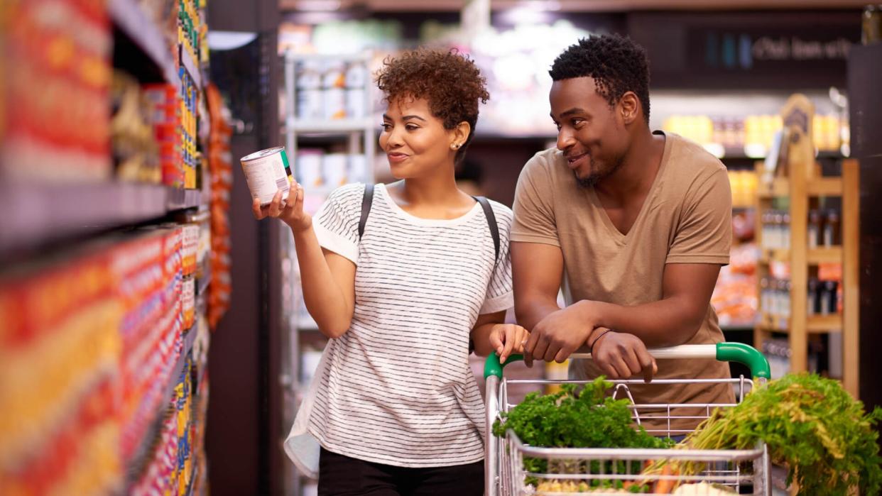 Shot of a young couple shopping in a grocery store.