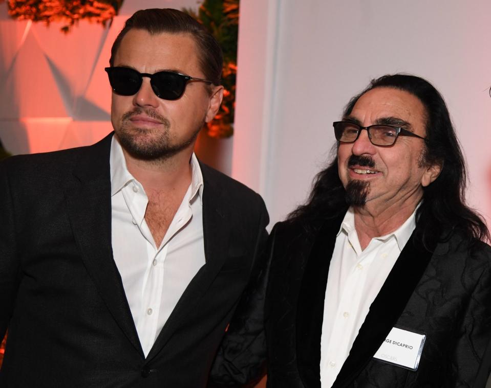 Leo and George stand together at an event