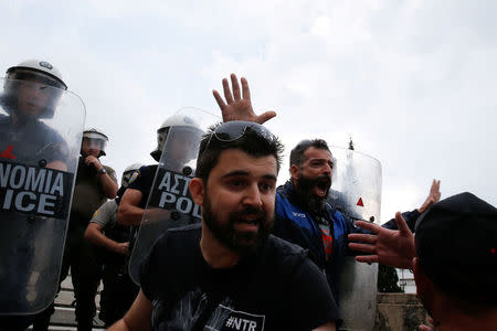 Protesters reacts in front of riot police during a demonstration against the agreement reached by Greece and Macedonia to resolve a dispute over the former Yugoslav republic's name, in Athens, Greece, June 16, 2018. REUTERS/Costas Baltas