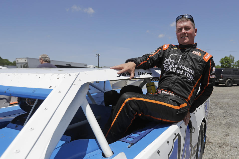 Andy Bishop climbs out of his car following a practice session at Gas City I-69 Speedway, Sunday, May 24, 2020, in Gas City, Ind. On a day usually reserved for IndyCar's crown jewel race, Gas City I-69 Speedway an hour's north of Indianapolis had a handful of cars on a short dirt track. (AP Photo/Darron Cummings)