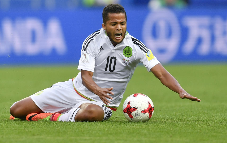 Mexico's Giovani Dos Santos grimaces as falls down during the Confederations Cup, Group A soccer match between Portugal and Mexico, at the Kazan Arena, Russia, Sunday, June 18, 2017. (AP Photo/Martin Meissner)