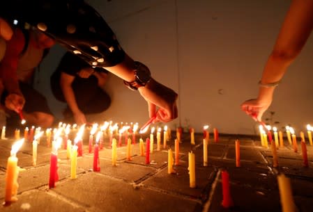 People light candles as they gather at Lennon Wall at Admiralty district during the Mid-Autumn Festival, in Hong Kong