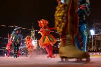 Skaters perform during the opening of an outdoor skating rink in the Red Square in Moscow