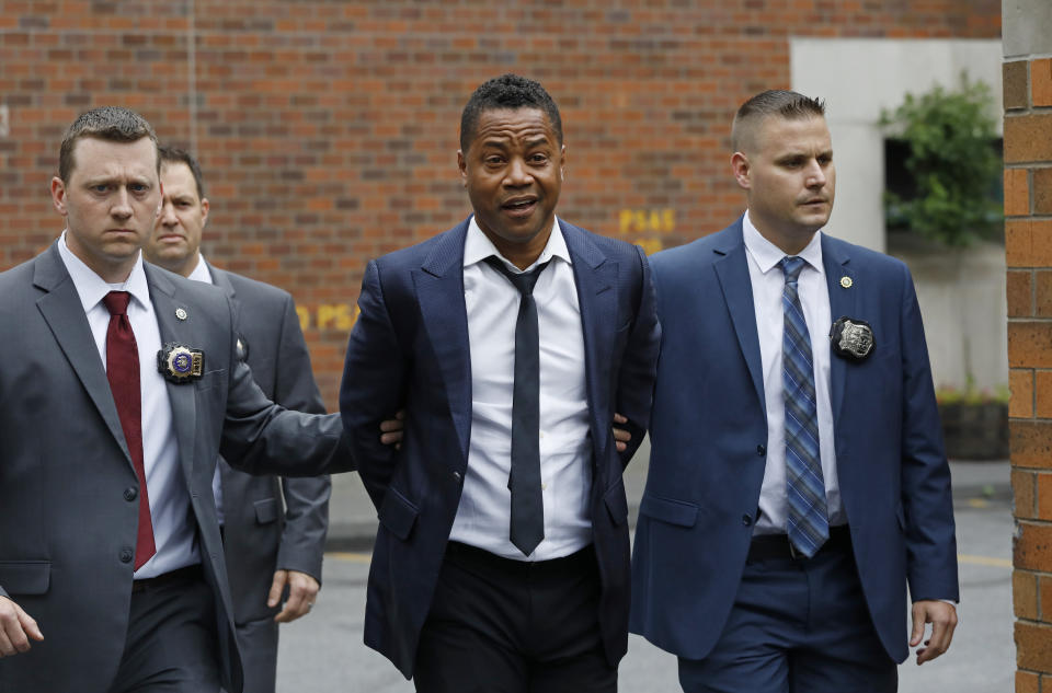 Actor Cuba Gooding Jr., center, is lead by police officers from the New York Police Department's special victims division, Thursday, June 13, 2019, in New York. Gooding Jr., 51, was arrested Thursday after turning himself in, was charged with forcible touching after a woman accused the actor of groping her at a New York City night spot. (AP Photo/Mark Lennihan)