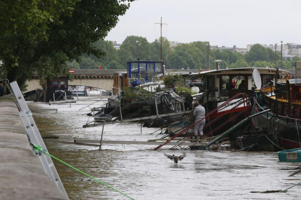 Houseboats are moored as high waters cover the banks of the Seine. <span class="inline-image-credit">(Reuters/Pascal Rossignol)</span>