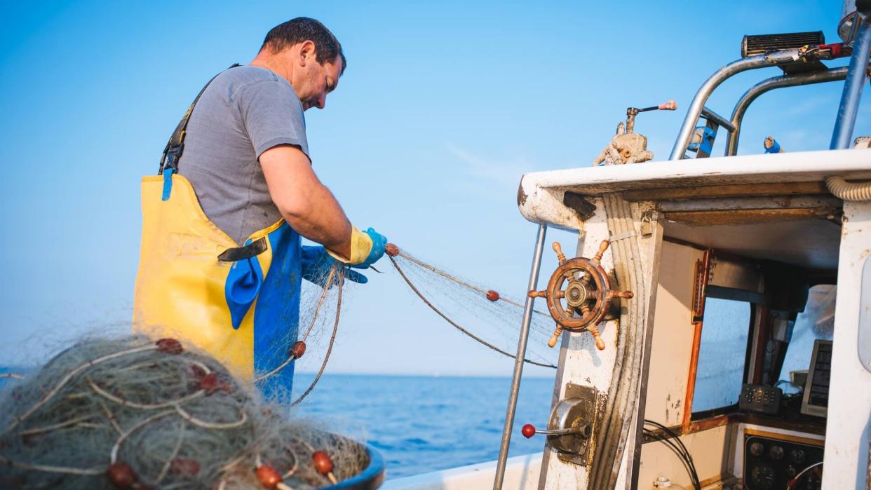 Fisherman pulling the net out of water.