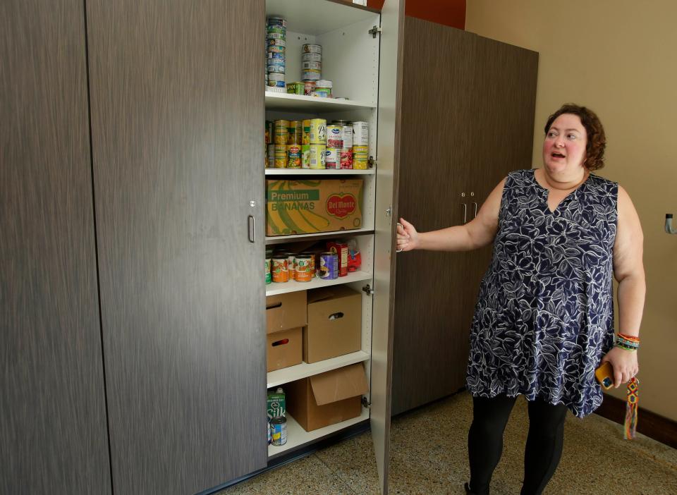 House Manager Emily Kunde stands by the food pantry The Production Farm has as part of its community projects,as seen during a tour, Wednesday, August 2, 2023, in Sheboygan, Wis.