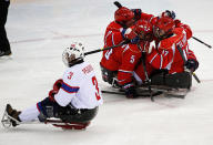 <div>HUDDLE - <span>Russia's players celebrate a goal as Norway's Einar Rolf Pedersen skates past during the semi-final sledge hockey game at the 2014 Sochi Winter Paralympic Games.</span></div>