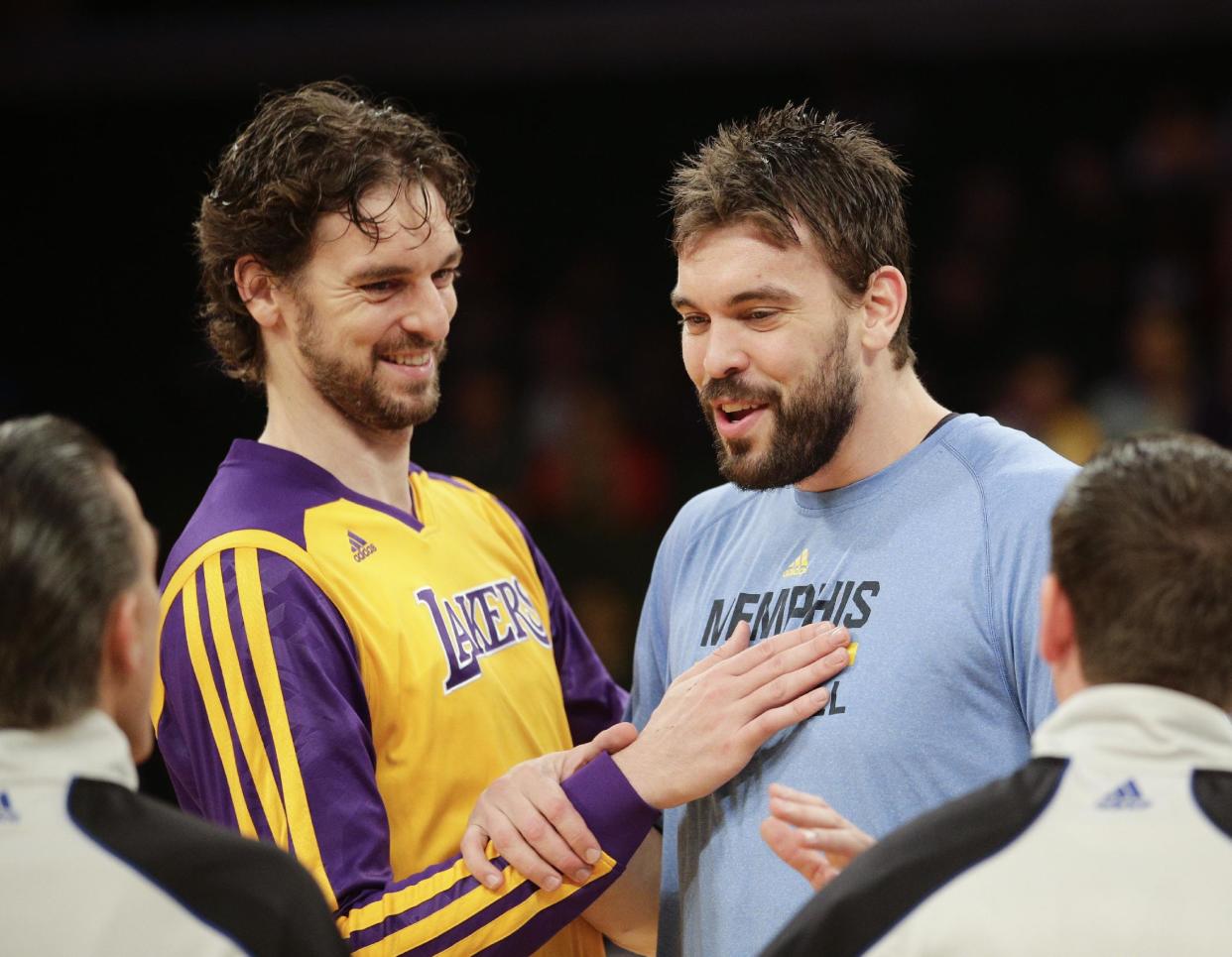 FILE - In this Nov. 15, 2013, file photo, Los Angeles Lakers&#39; Pau Gasol, left, and his brother, Memphis Grizzlies&#39; Marc Gasol talk to referees before an NBA basketball game in Los Angeles. Pau and Marc Gasol will make history Sunday, Feb. 15, 2015, when the Spanish centers become the first brothers to start against each other in the NBA All-Star game. (AP Photo/Jae C. Hong, File)