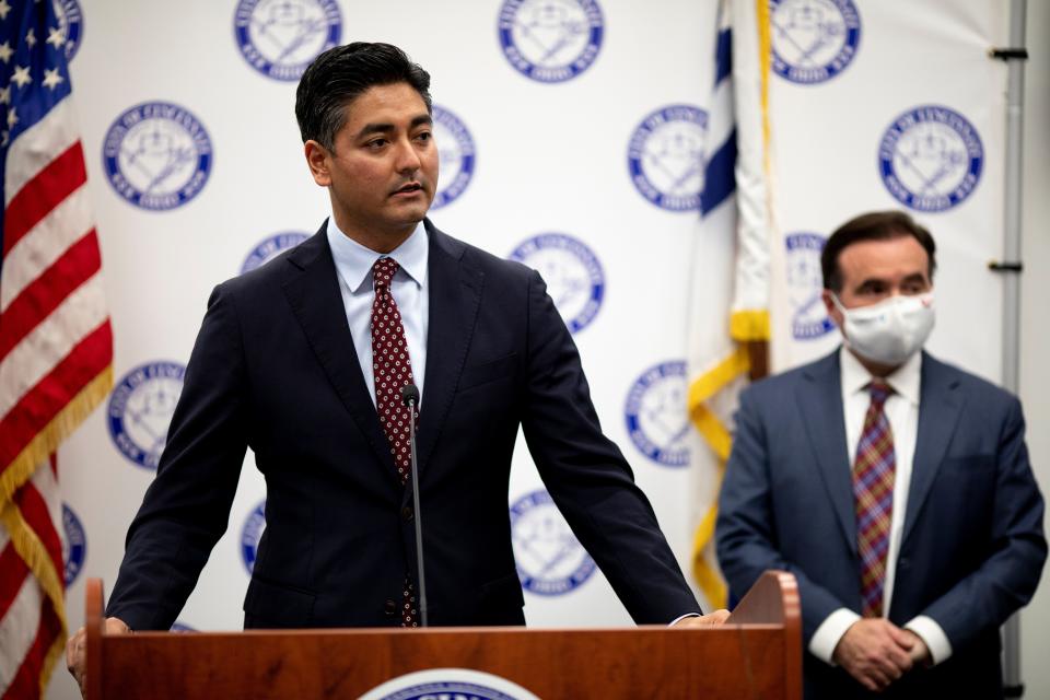 Mayor-elect Aftab Pureval speaks as Mayor John Cranley stands behind him during a press conference updating the COVID-19 pandemic ahead of the holidays on Tuesday, Dec. 21, 2021, in Cincinnati.