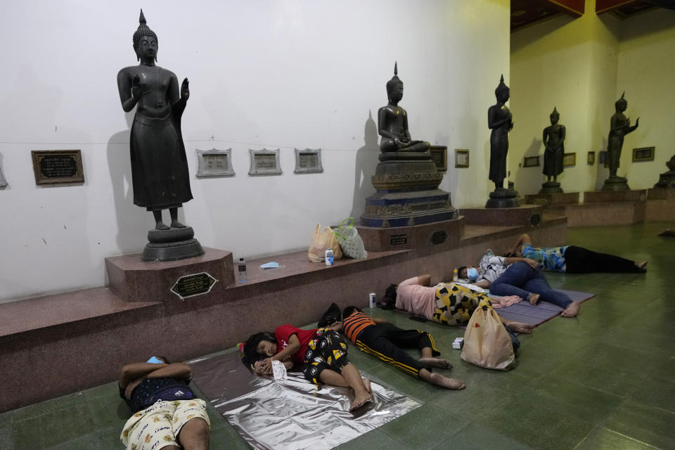 Locals sleep in line overnight for free coronavirus testing at Wat Phra Si Mahathat temple in Bangkok, Thailand, Friday, July 9, 2021. Faced with rapidly rising numbers of new coronavirus infections and growing concern over the proliferation of the highly contagious delta variant, major Asia-Pacific cities implemented new restrictions Friday in the hope of reversing the trend before health care systems are overwhelmed. (AP Photo/Sakchai Lalit)