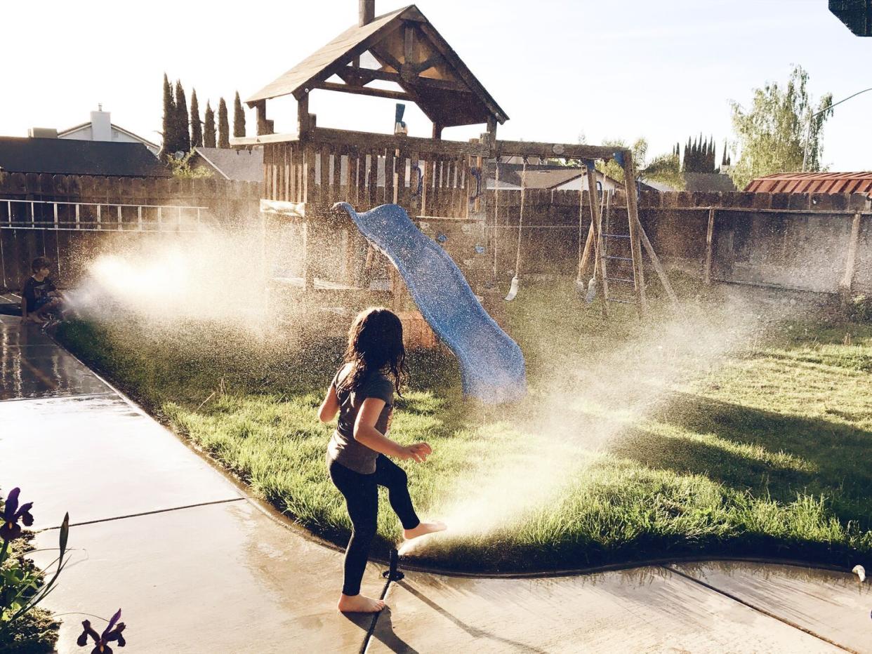 kids running in sprinklers