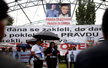 Members of two families speaks and hold placards during protest in Sarajevo, Bosnia and Herzegovina May 15, 2018. REUTERS/Dado Ruvic