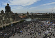 A plume from a fire extinguisher fired by the police to disperse demonstrators rises outside Mexico's Presidential Palace during a march commemorating International Women's Day in Mexico City, Monday, March 8, 2021. (AP Photo/Fernando Llano)