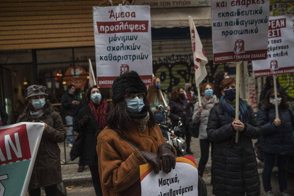 Primary school teachers wearing face masks protest outside Health Ministry demanding more safety measures in schools against the coronavirus pandemic, in Athens, Friday, Jan. 15, 2021. Primary schools and kindergartens reopened this week, but high school lessons are being held online only.Greece's prime minister says the country's retail sector might begin to gradually reopen next week, if the scientists advising the government on the coronavirus pandemic recommend it is safe to do so today. (AP Photo/Petros Giannakouris)