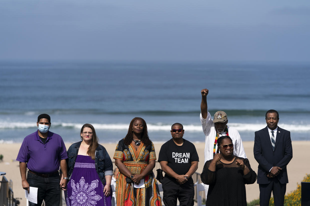 From left: Anthony Bruce, a great-great grandson of Charles and Willa Bruce; wife, Sandra; Kavon Ward, founder of Justice for Bruce's Beach; Derrick Bruce, great grandson of Charles and Willa Bruce; Chief Duane Yellow Feather Shepard and Mitch Ward attend a dedication ceremony in Manhattan Beach, Calif., Wednesday, July 20, 2022. (AP Photo/Jae C. Hong)