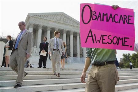 Supporters of the Affordable Healthcare Act gather in front of the Supreme Court before the court's announcement of the legality of the law in Washington on June 28, 2012. REUTERS/Joshua Roberts
