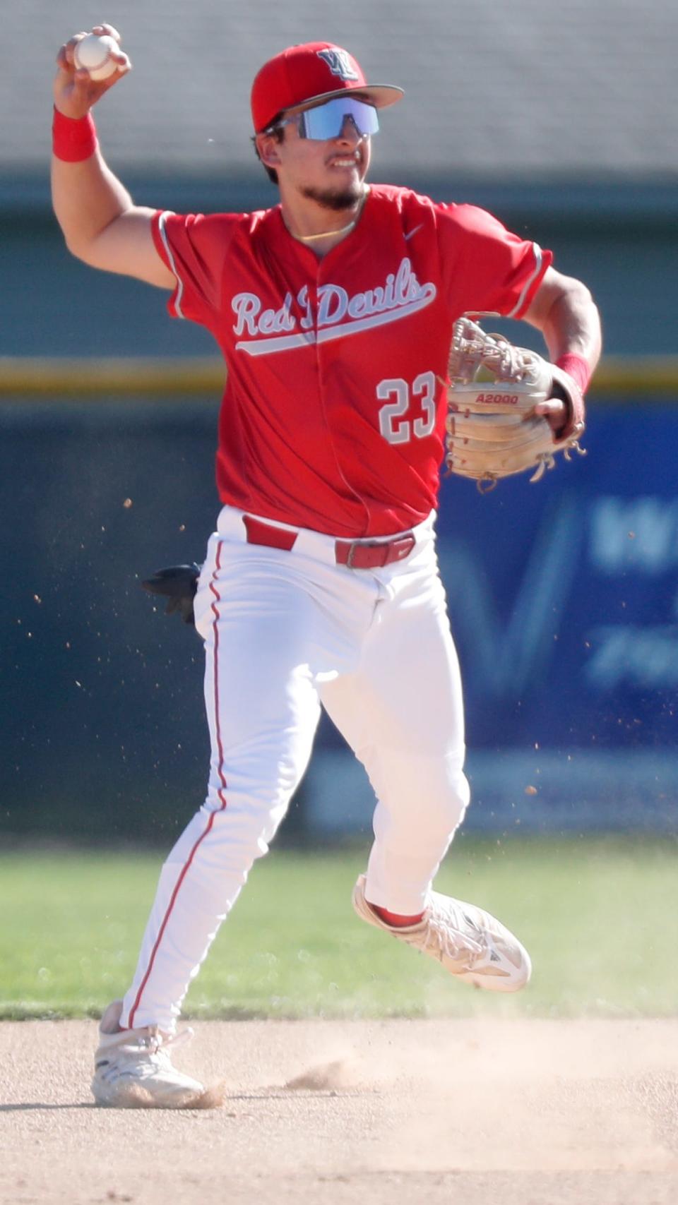 West Lafayette Red Devils Manny Gaeta (23) throws the ball to first base during the IHSAA baseball game against the Harrison Raiders, Thursday, April 13, 2023, at West Lafayette High School in West Lafayette, Ind. Harrison won 14-4.
