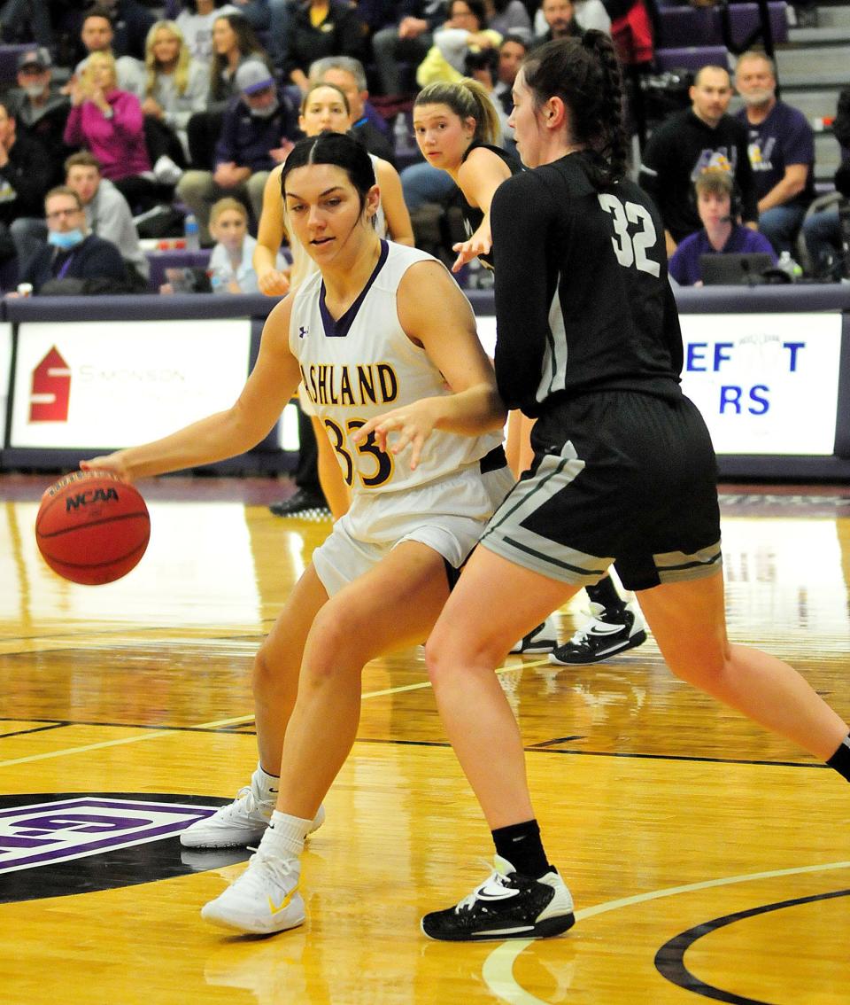 Ashland University's Hayley Smith (33) takes the ball around the defense of Lake Erieâ€™s Breanna Bauer (32) basketball action at Ashland University Sat. Dec. 11, 2021.  LIZ A. HOSFELD/FOR TIMES-GAZETTE.COM