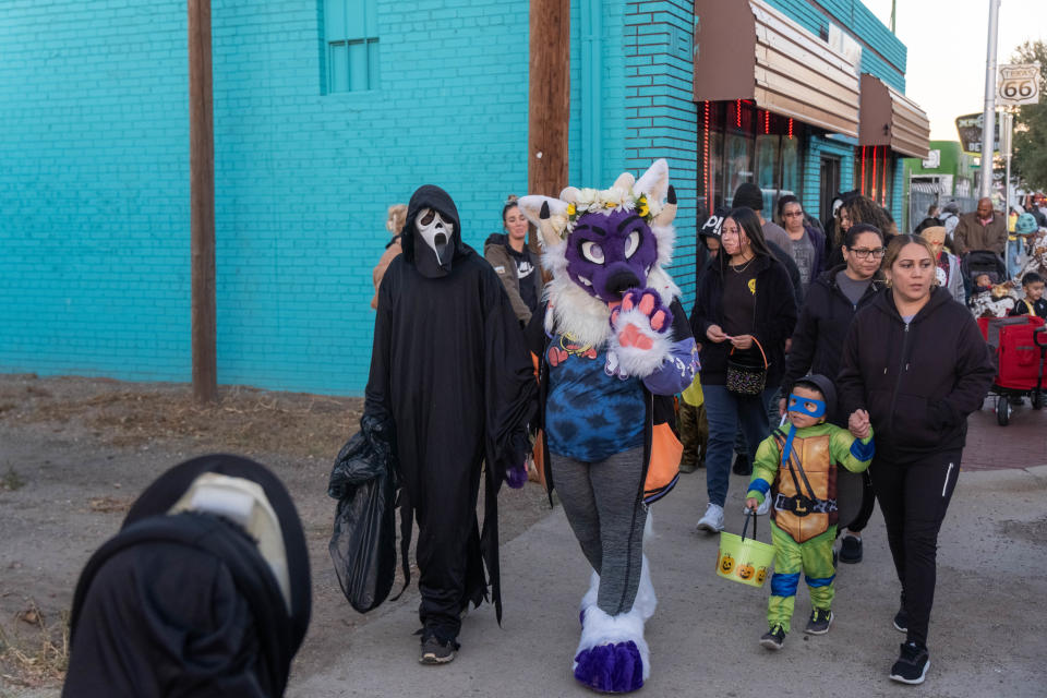 Trick-or-treaters make their way down Route 66 Tuesday at the 6th Street Creepy Crawl in Amarillo, Texas.