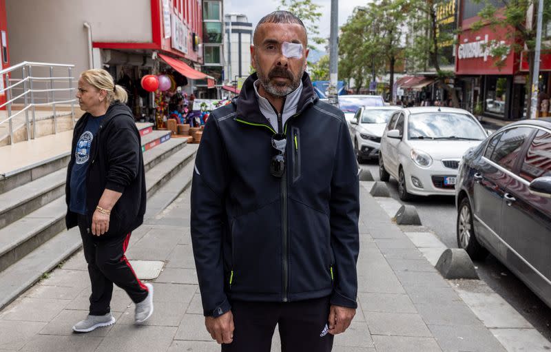 Hakan Yaman poses for a picture at the street where he was wounded during Gezi Park protests in Istanbul