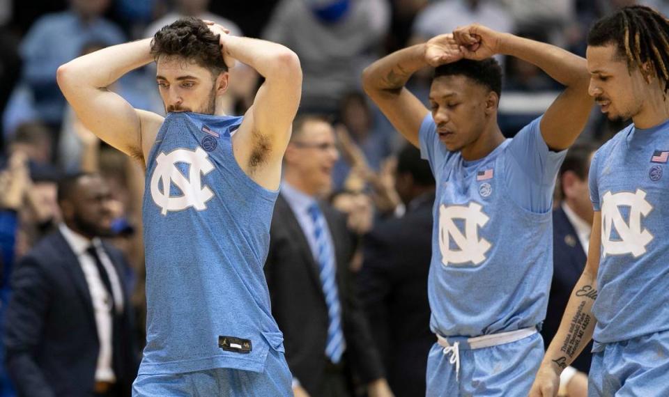 North Carolina’s Andrew Platek (3), Christian Keeling (55) and Cole Anthony (2) leave the court dejected after Duke defeated the Tar Heels’ 98-96 in overtime on Saturday, February 8, 2020 at the Smith Center in Chapel Hill, N.C.