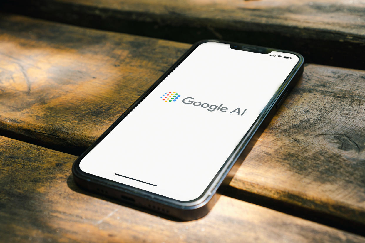  Google AI logo on phone laying on a table. 