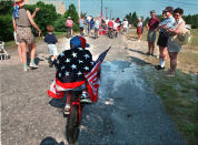 <p>Five-year-old Sean Kennedy in the annual Fourth of July Parade bicycles through the streets of Mashnee, Mass., 1995. (Photo: Suzanne Kreiter/The Boston Globe via Getty Images) </p>