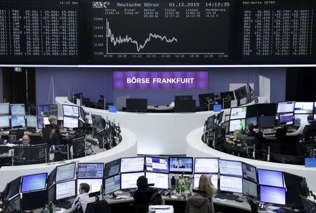 Traders are pictured at their desks in front of the DAX board at the stock exchange in Frankfurt, Germany, December 1, 2015. REUTERS/Staff/Remote