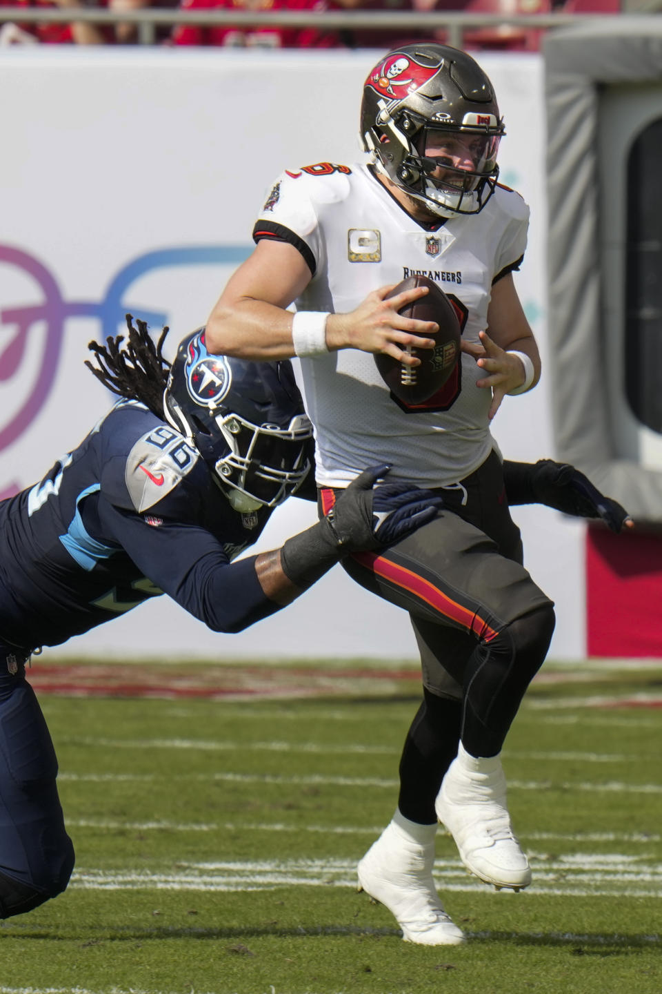 Tennessee Titans defensive end Denico Autry (96) tackles Tampa Bay Buccaneers quarterback Baker Mayfield, right, during the first half of an NFL football game Sunday, Nov. 12, 2023, in Tampa, Fla. (AP Photo/Chris O'Meara)
