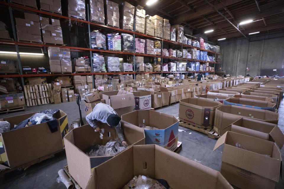 Boxes of goods are sorted in the staging area at JT's Merchandise Outlet in Santa Fe Springs.