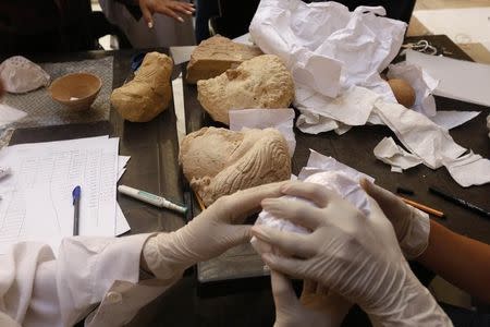 Workers arrange antiquities in Damascus, Syria August 18, 2015. REUTERS/Omar Sanadiki